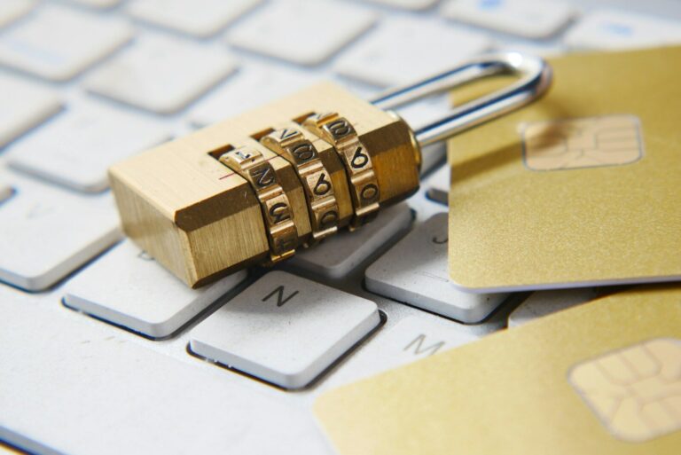 a golden padlock sitting on top of a keyboard - password manager